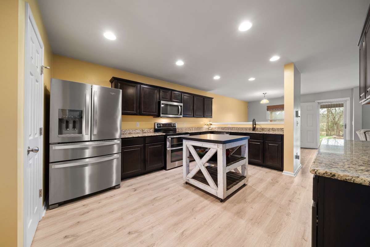 The large kitchen with stainless steel appliances and lots of cabinets/countertop space. (Mobile Island does not stay)