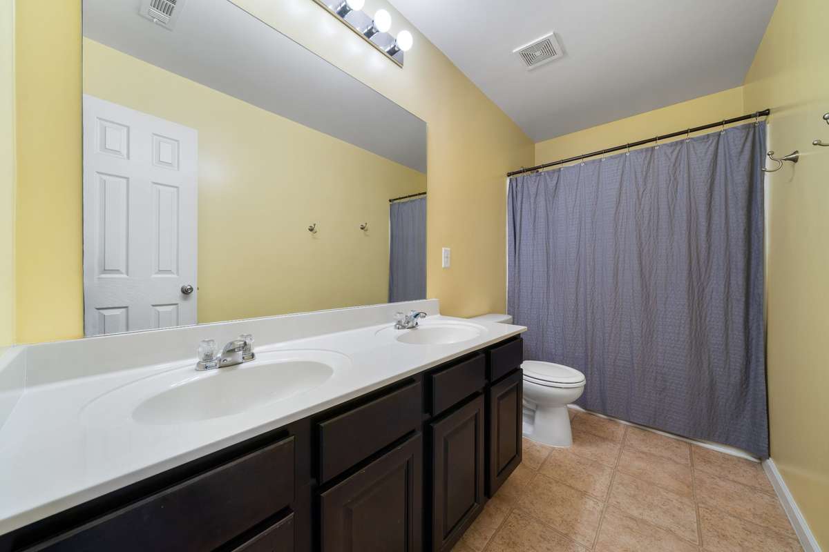 Upstairs Bathroom: This bathroom upstairs in right off the stairs, making it easily accessible to the whole house.