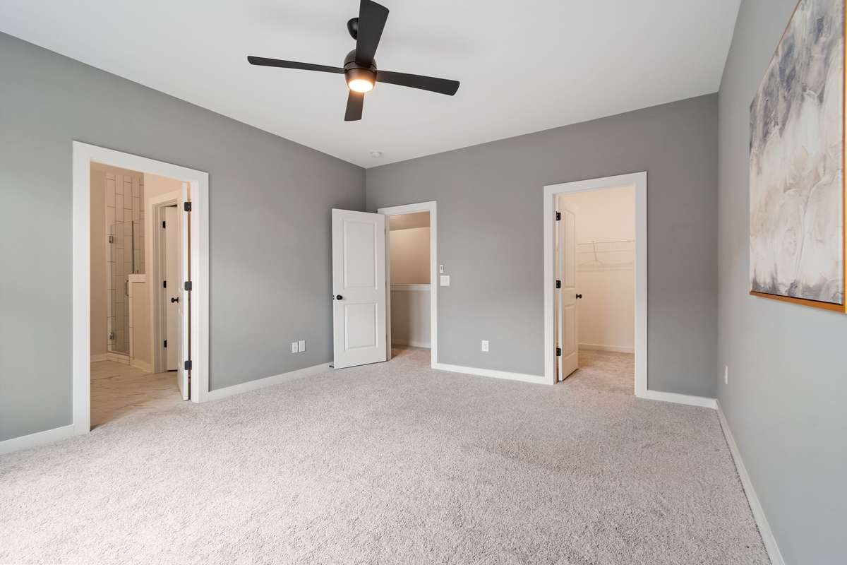 The primary bedroom opens up to a deluxe bathroom and walk-in closet