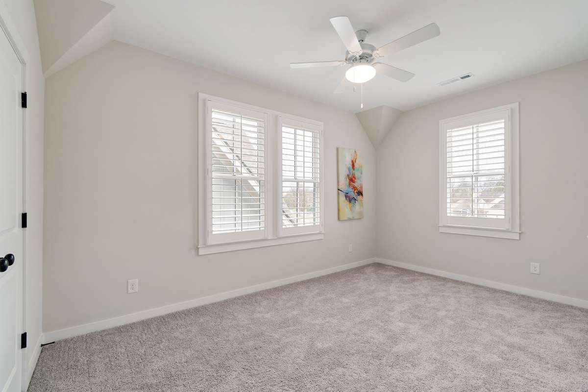 Upstairs corner bedroom with two walls of windows