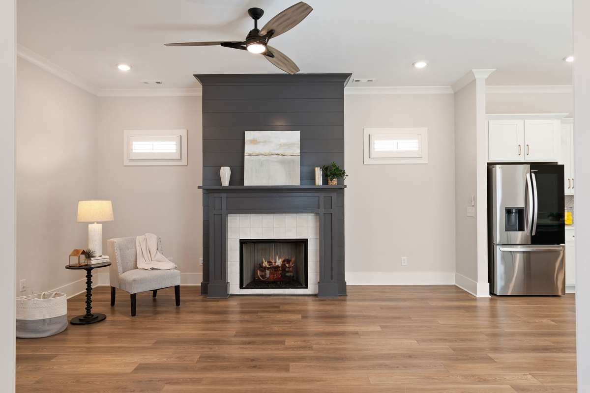 This room is flanked by twin windows and a gas logged fireplace.
