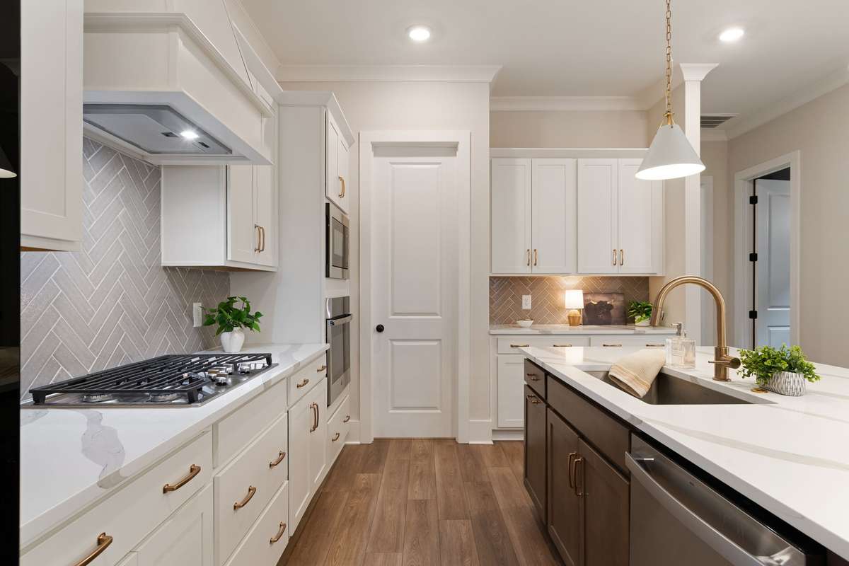 A natural gas grill range and brand new refrigerator freezer remain.