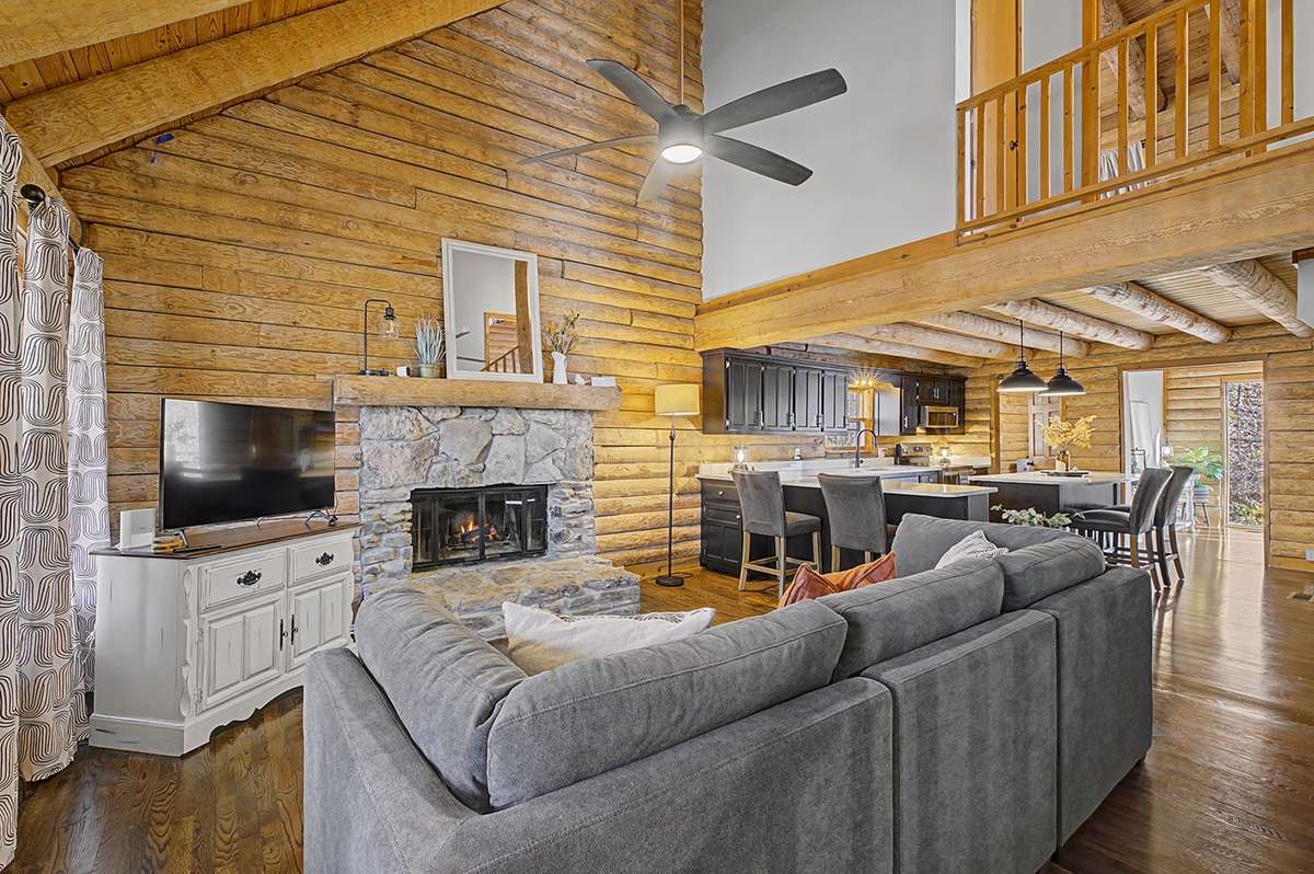 Feature stone fireplace w/exposed wood details