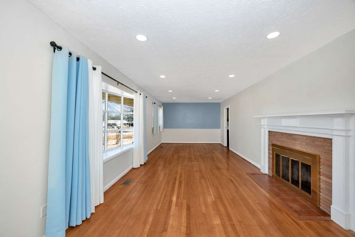 Combined Living & Dining Room- Wood flooring, recessed lighting, fireplace