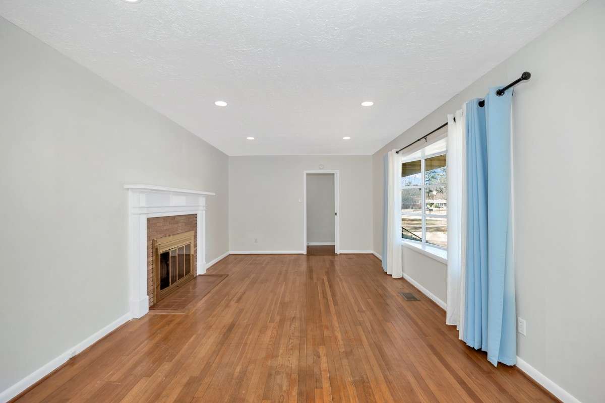 Living room- wood flooring, recessed lighting, fireplace