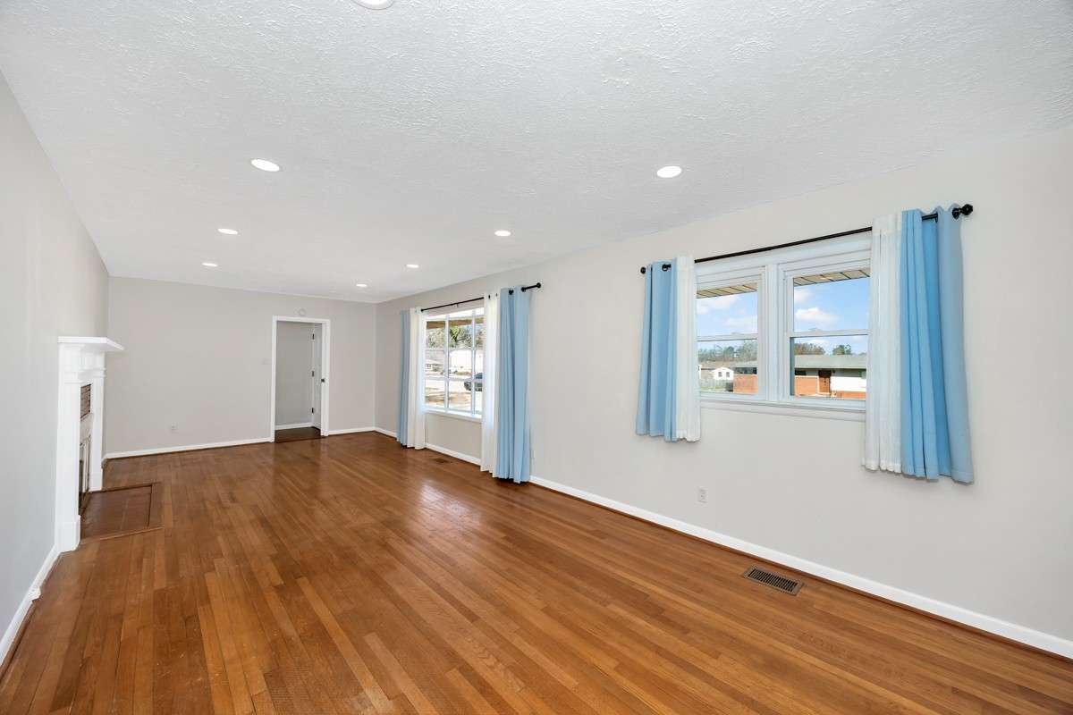 Living Room- wood flooring, recessed lighting, fireplace