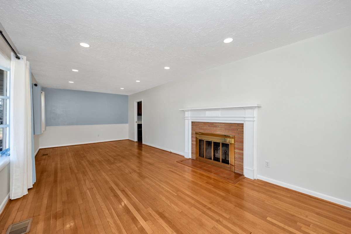 Combined Living & Dining Room- Wood flooring, recessed lighting, fireplace