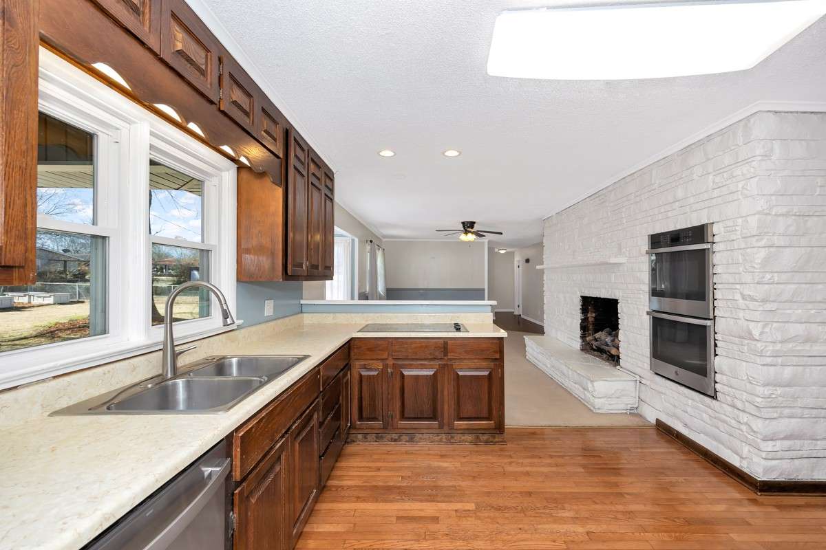 Kitchen- wood flooring, crown molding, wood cabinetry, stainless steel appliances, recessed lighting