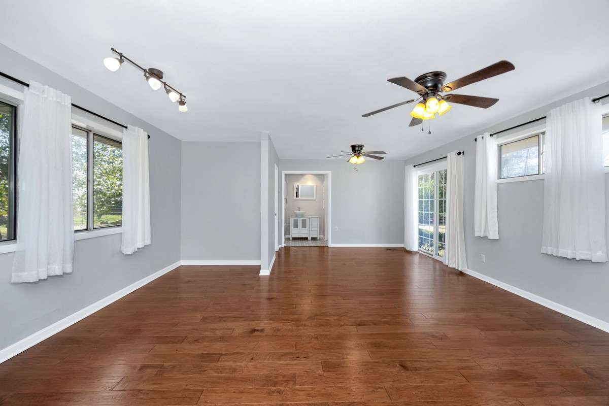 Primary Bedroom- Wood flooring, ceiling fans, 3/4 bath