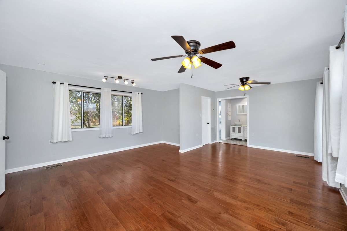Primary Bedroom- Wood flooring, ceiling fans, 3/4 bath