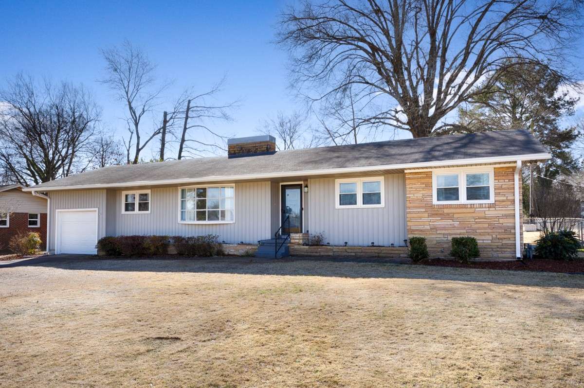 Front of house- Vinyl Siding, concrete driveway, attached single car garage, covered front porch, simple landscaping