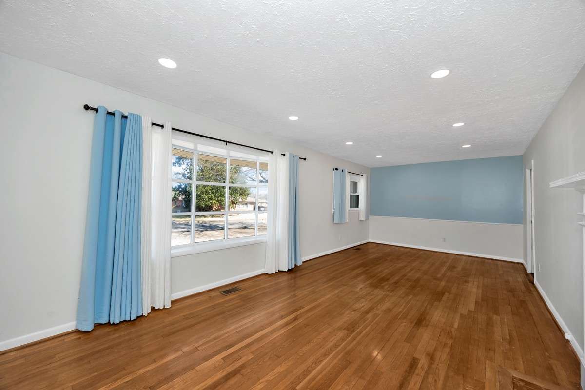 Combined Living & Dining Room- Wood flooring, recessed lighting, fireplace