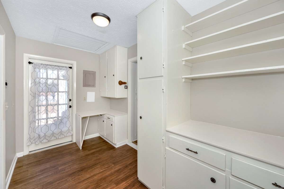 Other Room- Vinyl flooring, built in desk, cabinets and shelving