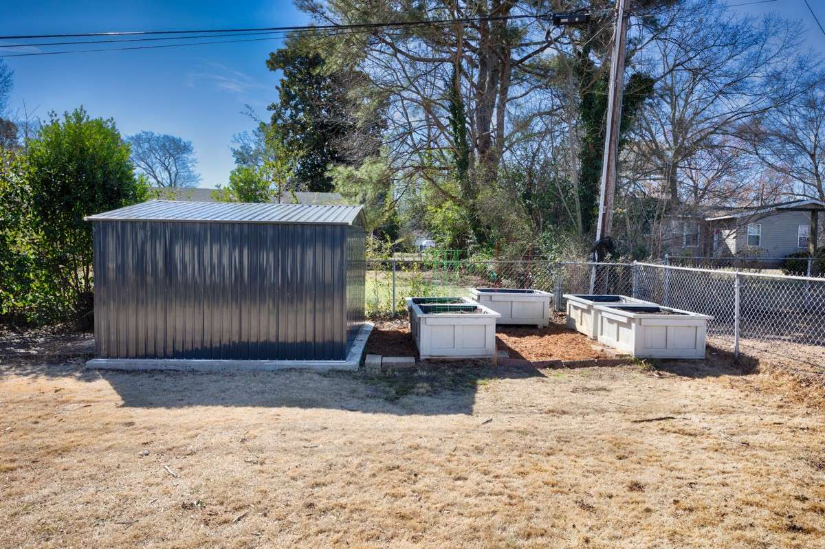 Yard- fenced area, storage shed, raised gardening beds