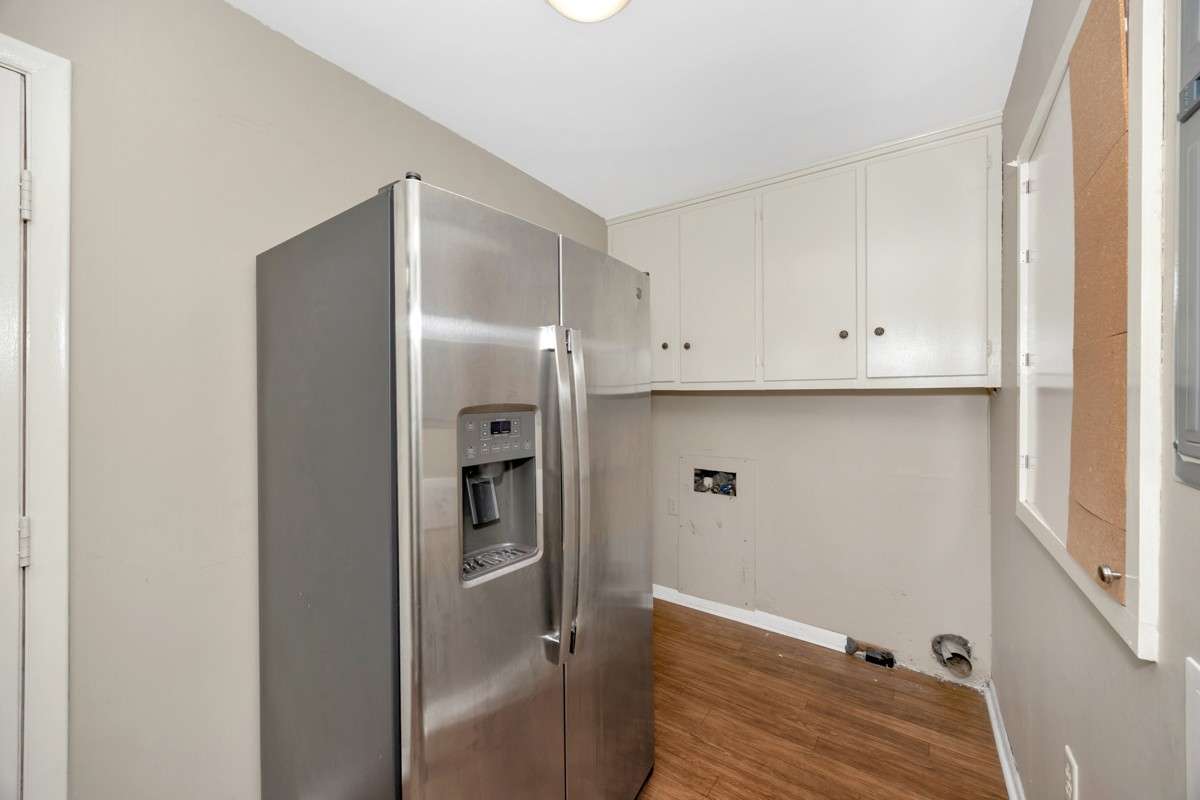 Laundry Room- vinyl flooring, washer/dryer connections, cabinetry for storage