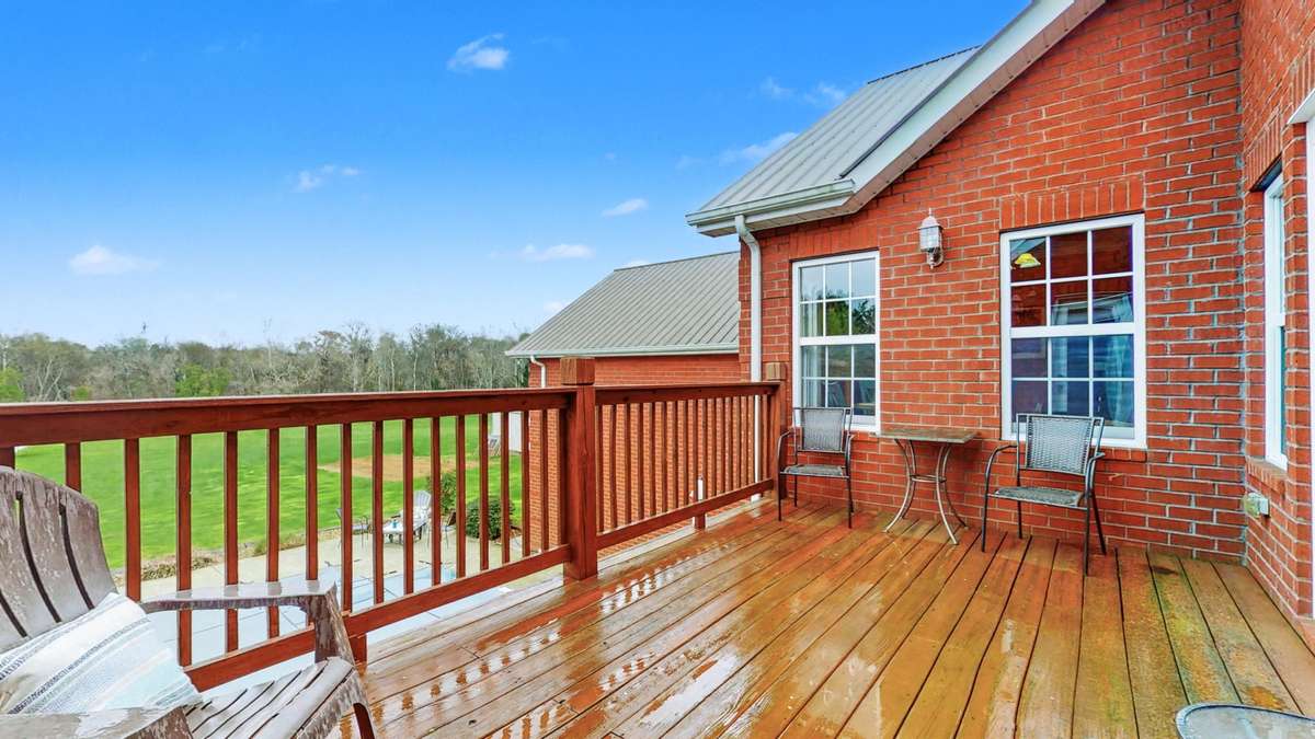 2nd floor decking overlooking inground pool.