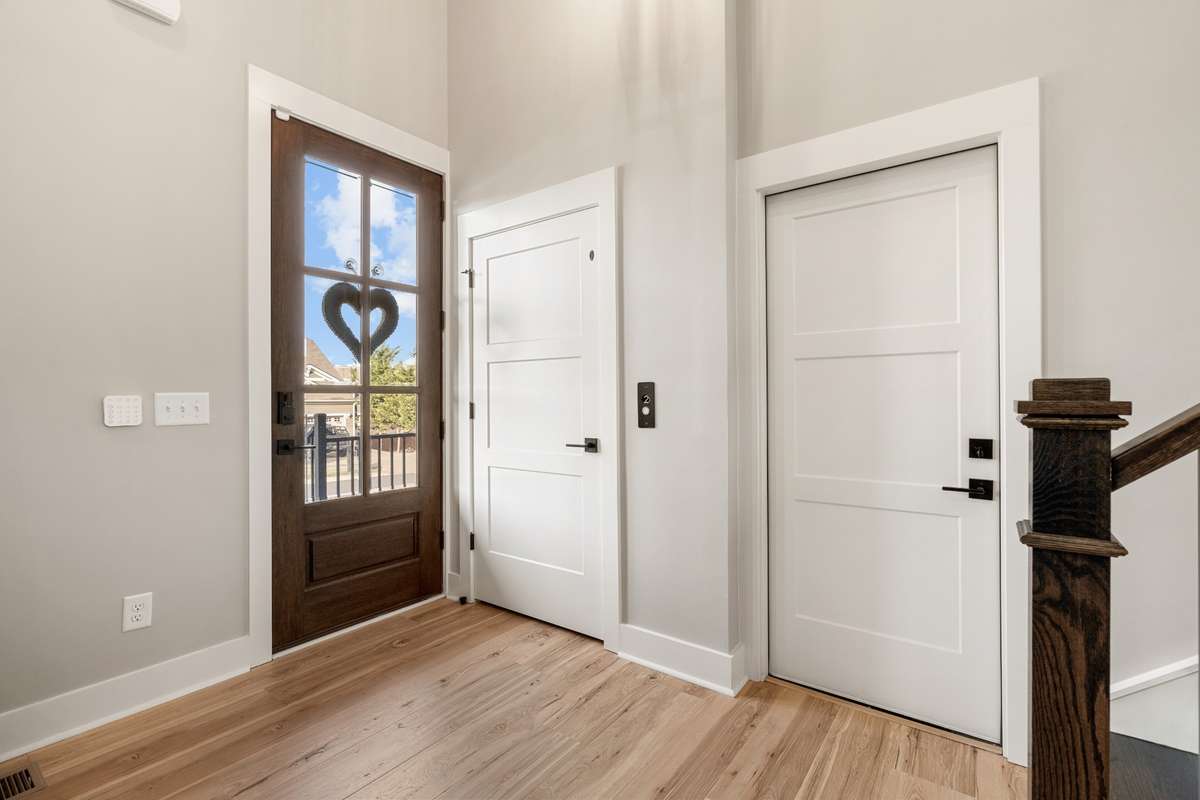 Front door and entry way with door to elevator and door to garage.