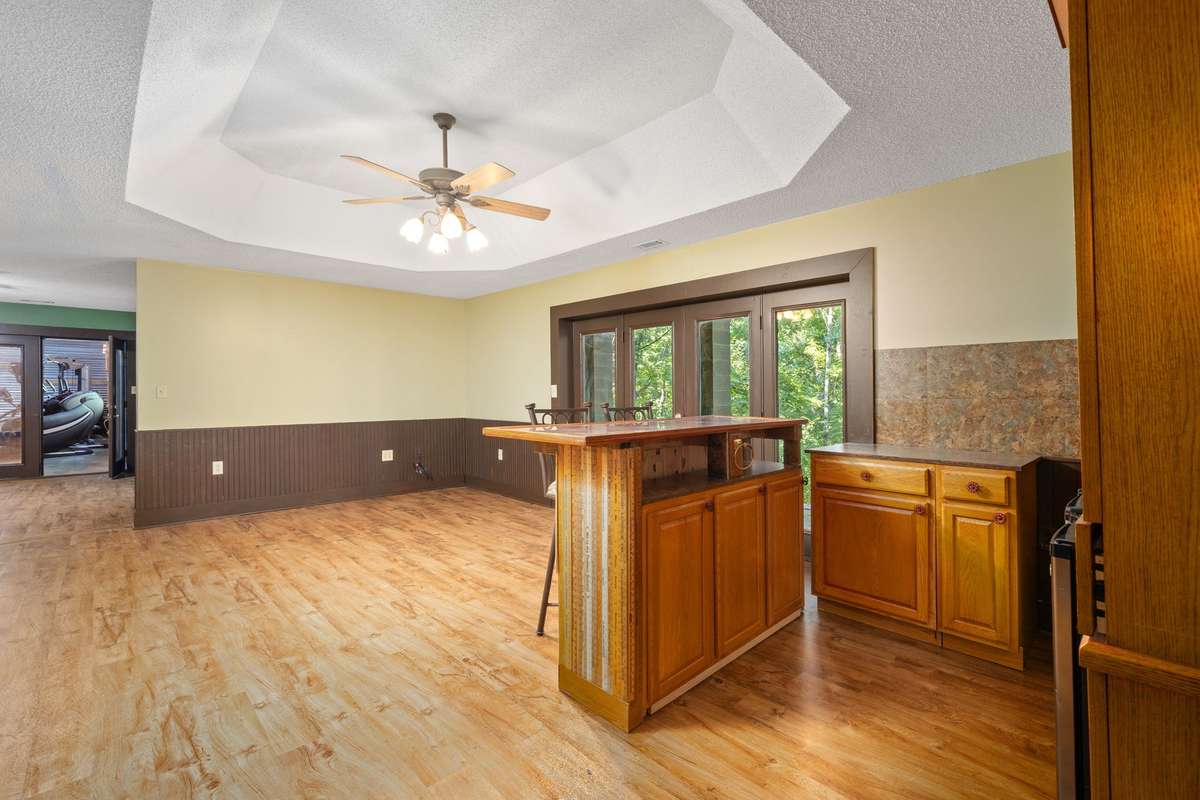 Recreational Room - located in basement - French doors exit to covered porch with wooded views