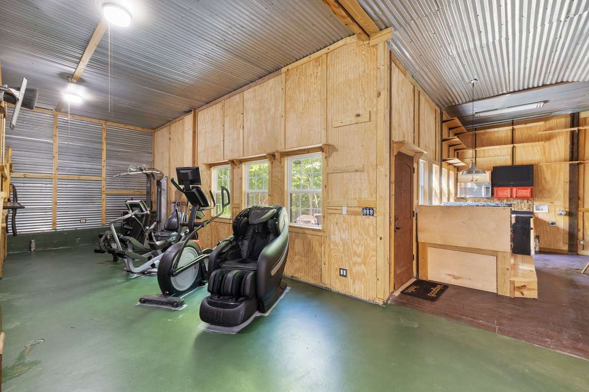 Pool / exercise room - with sauna, swim spa, and steam shower and attached kitchenette with washer / dryer hook-ups