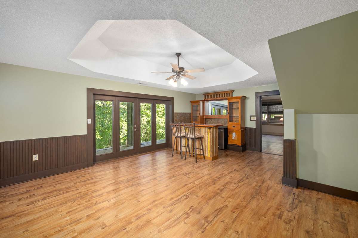 Recreational Room - located in basement - French doors exit to covered porch with wooded views