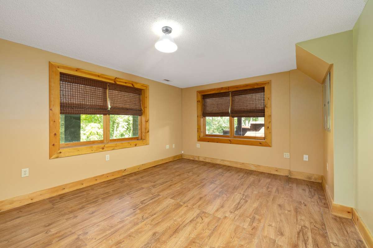 Bedroom #4 located in basement- large walk-in closet and wooded views