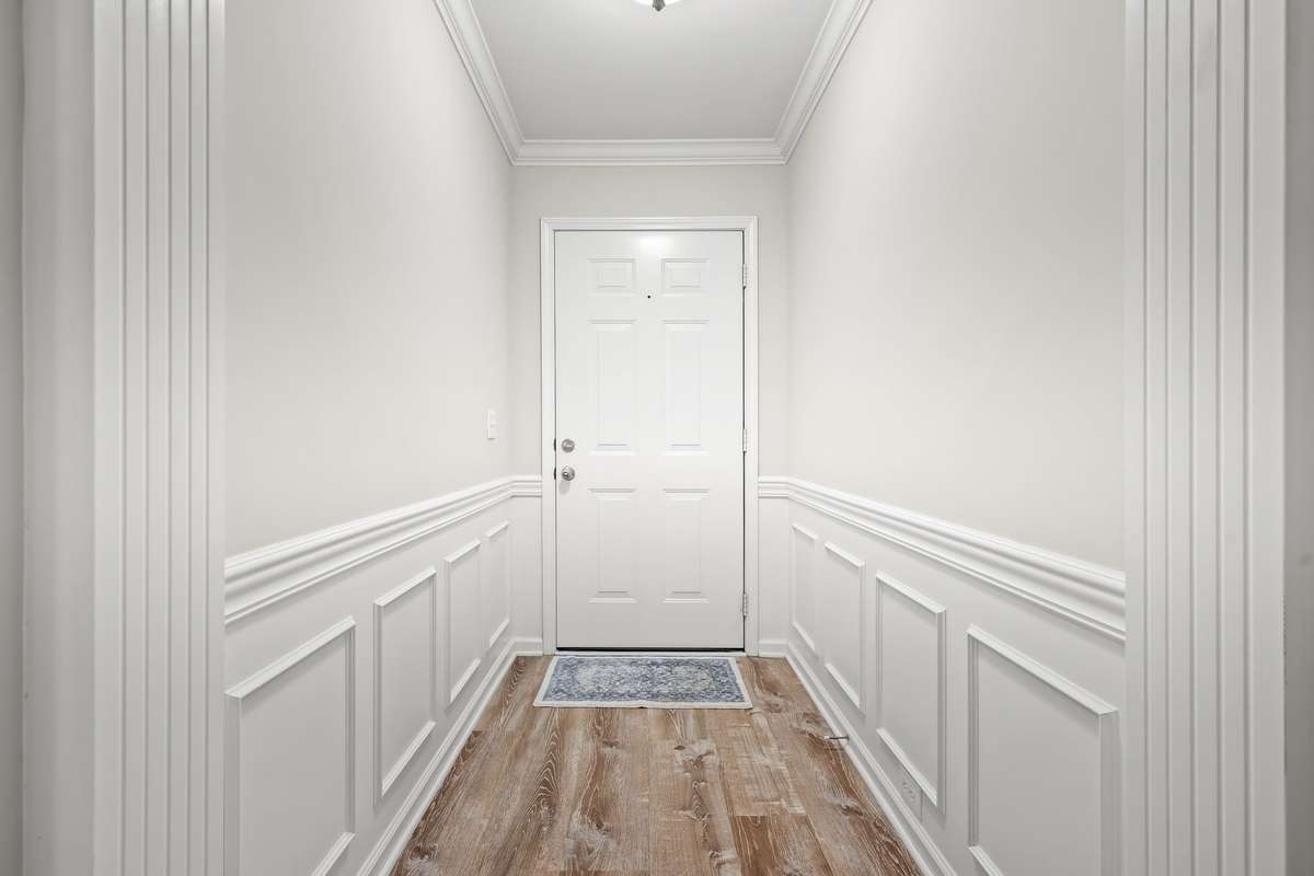 Foyer area allows you to greet guests before entering the main living areas.  Wainscoting brings a level of elegance.
