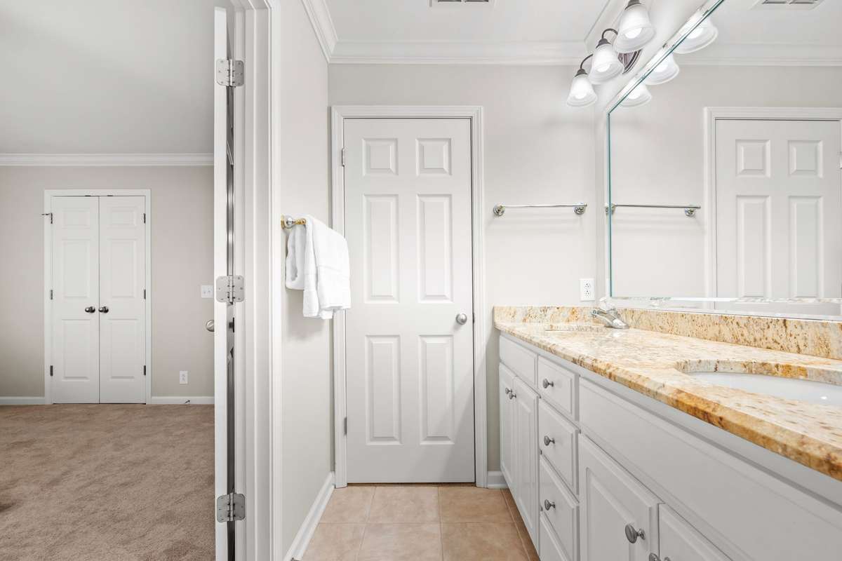Primary bathroom has double bowl vanity and it's own walk in closet.