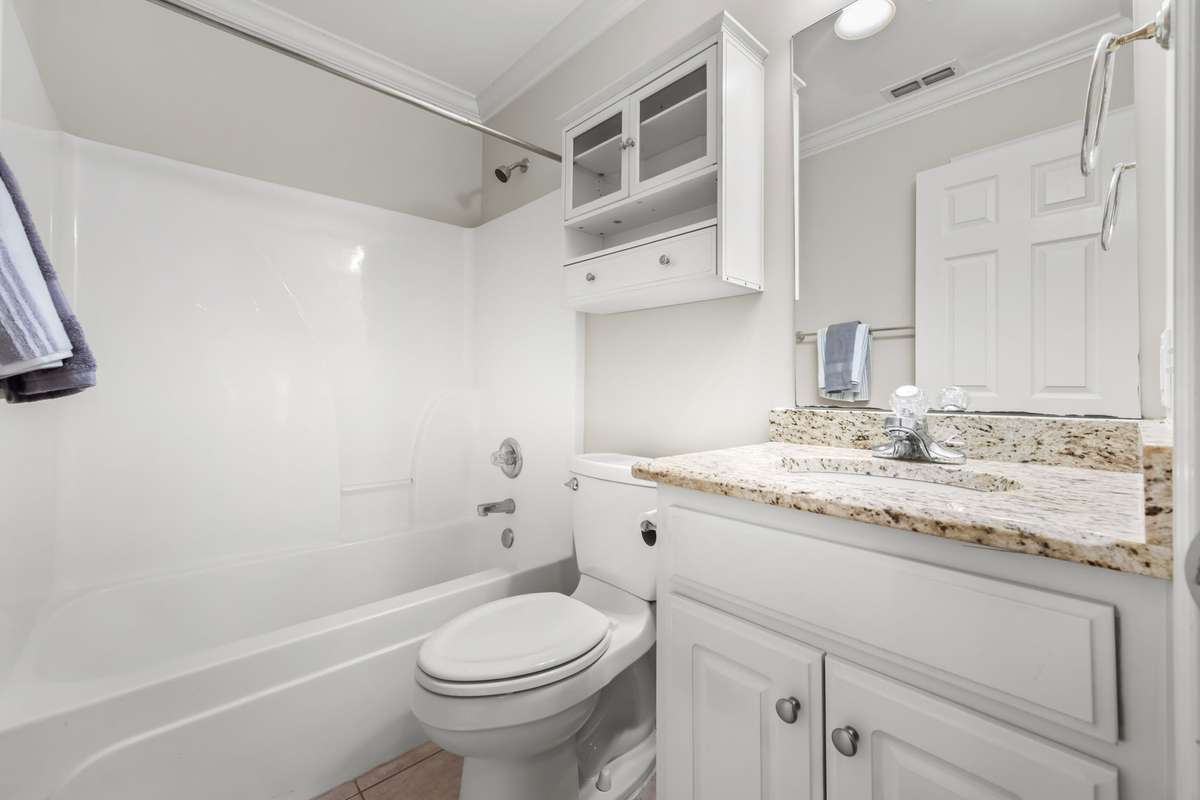 Full bathroom accessible from the hallway for visiting guests. Granite countertops give it an upscale feel.