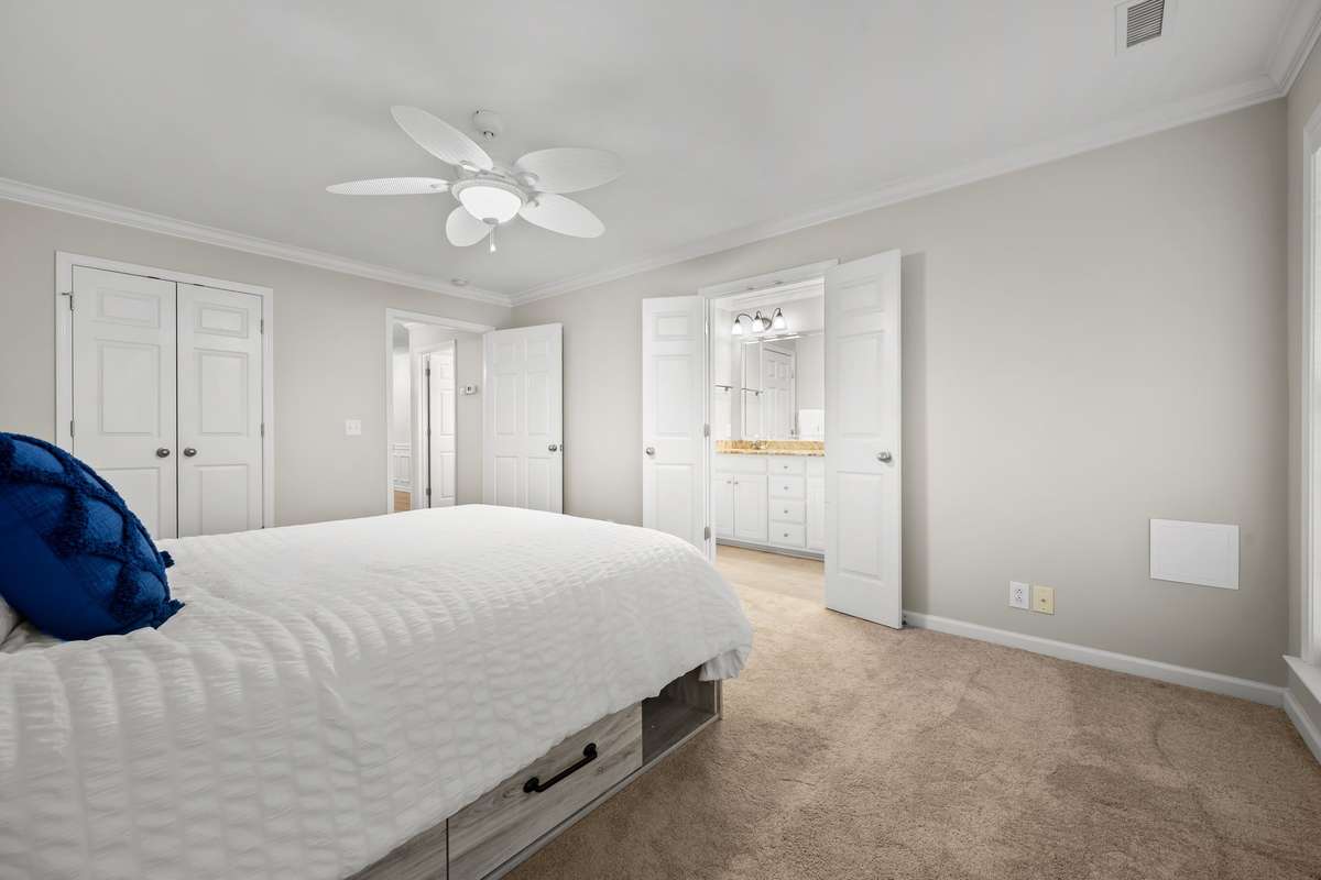 Another view of primary bedroom, looking towards walk in closet and bathroom.