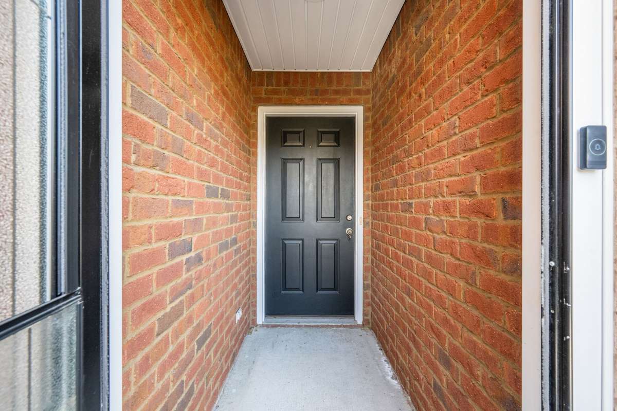 Entryway between storm door and front door, helps keep your front door step tidy and guests out of the rain.