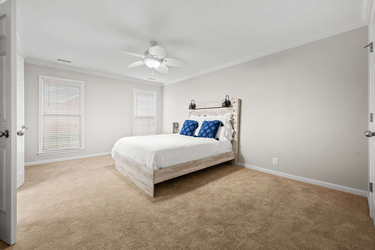 Primary bedroom is freshly painted and ready for new family.  Windows look out over rear of home.