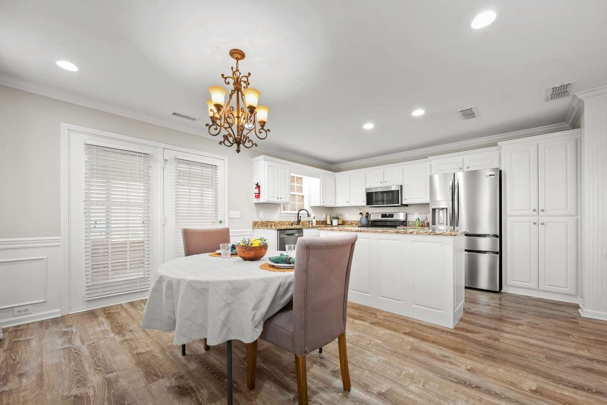 Dining space has elegant wainscoting and has plenty of space for large table and hutch.