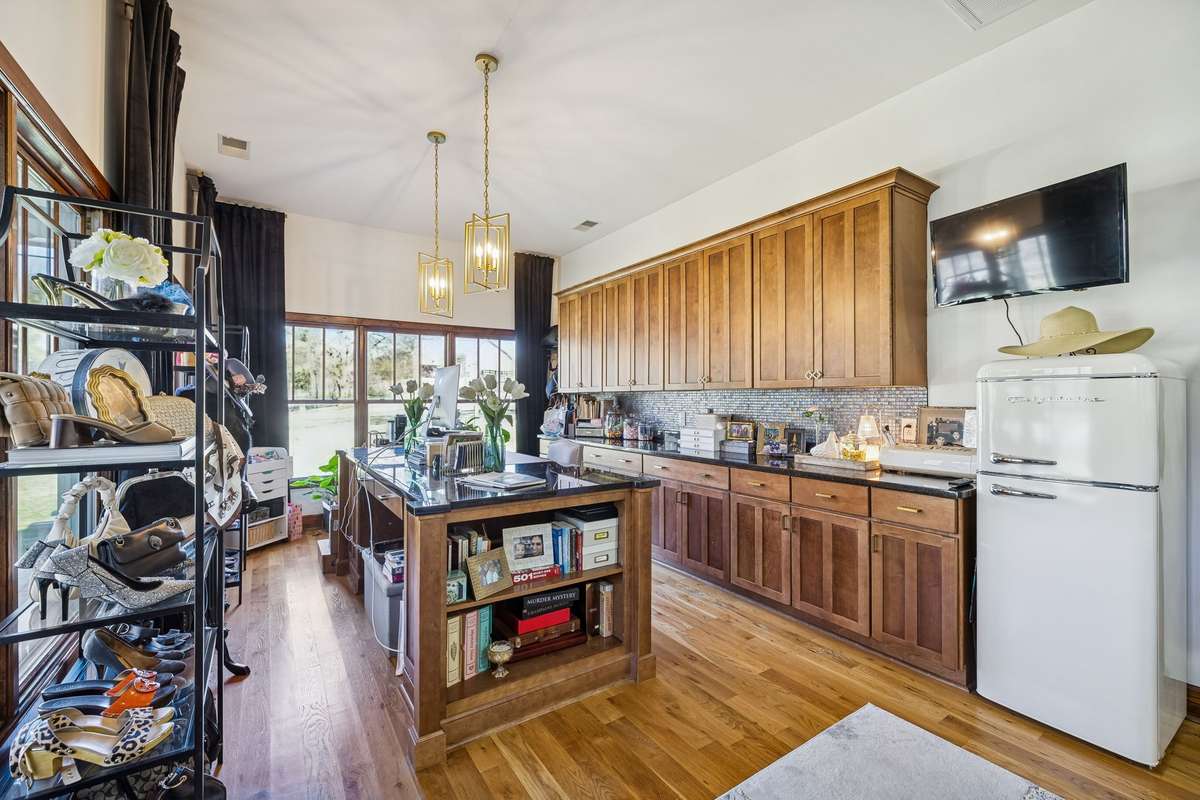 This is the second office area (small refrigerator does not remain), but look at the cabinetry and counter space. This office desk/counter in the middle is 4x8 with granite countertops throughout.