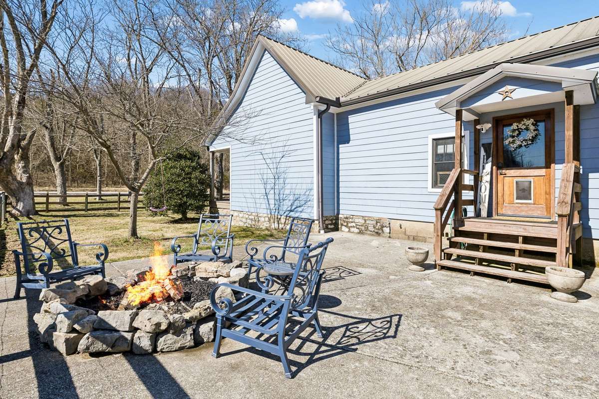 Side entrance (where agents & prospective buyers will enter the home). This patio area is home to a firepit for evening relaxation (and maybe some S'Mores!!!).