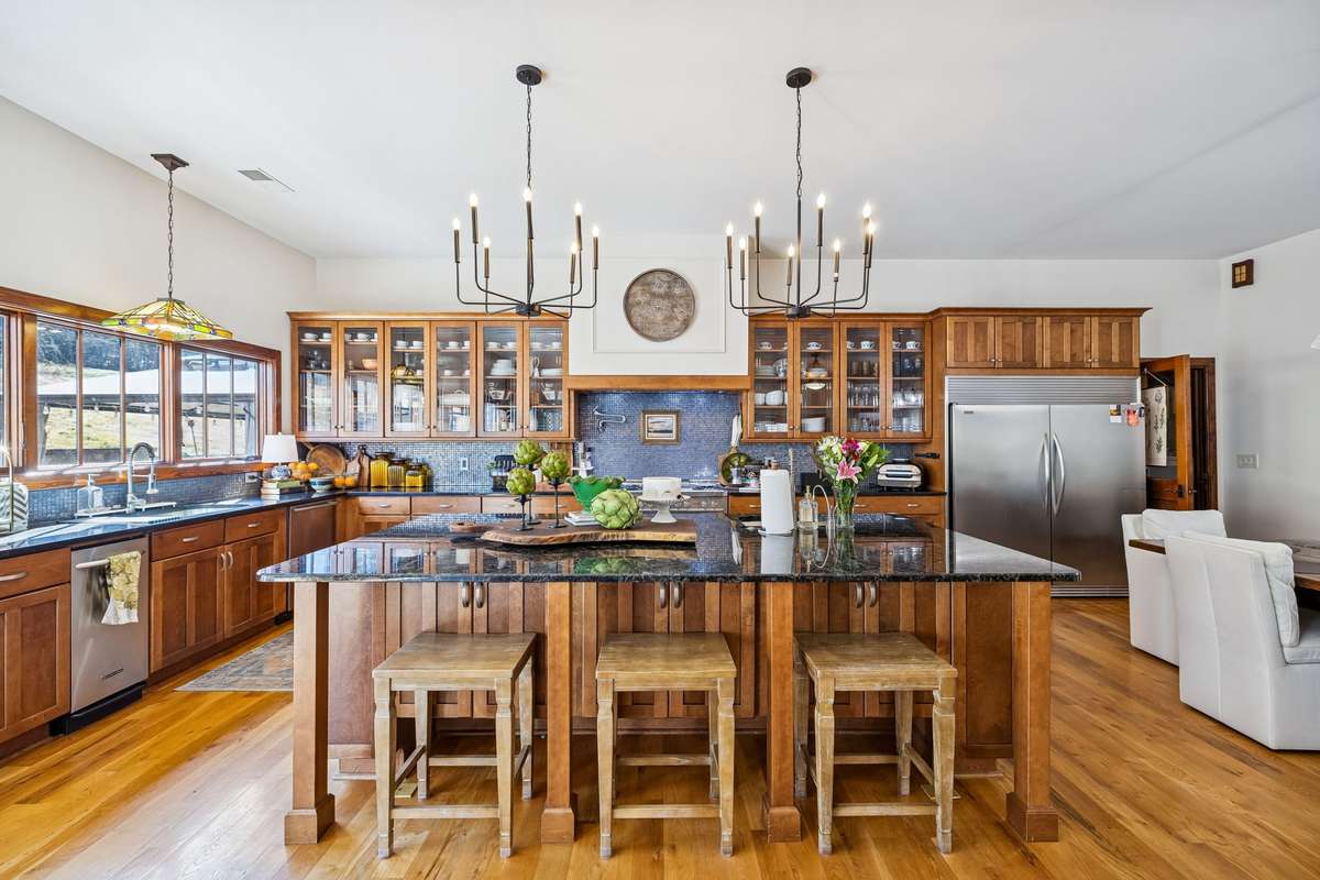 Imagine having this as your Kitchen! It's large with granite counters, a 5 x 10 island, a double refrigerator/freezer, compactor, dishwasher, 2 sinks with disposals, microwave, dishwasher & 7 burner propane gas Hallmark range w/2 ovens!