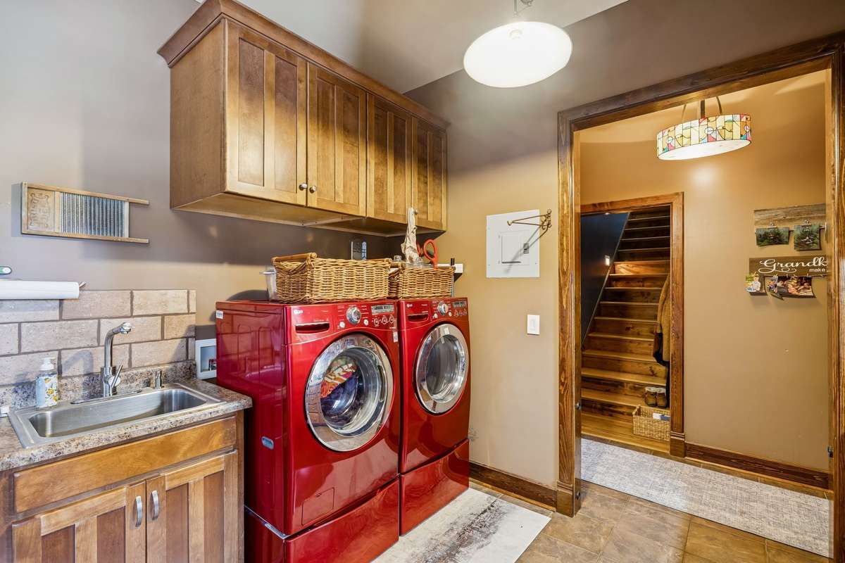 There's a sink and additional cabinets in the Laundry area.  The hallway goes to the home or the attached garage.  The stairway goes to the second floor room!