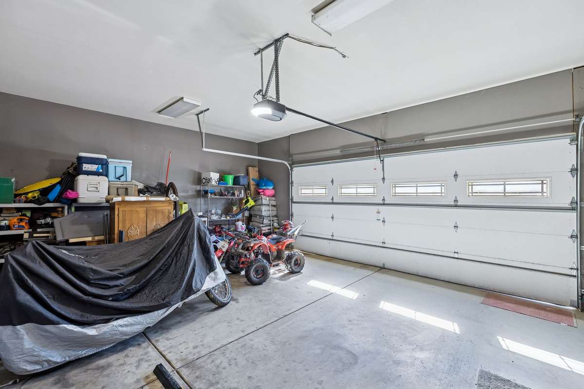 Attached 2-car garage with storage area toward the rear.