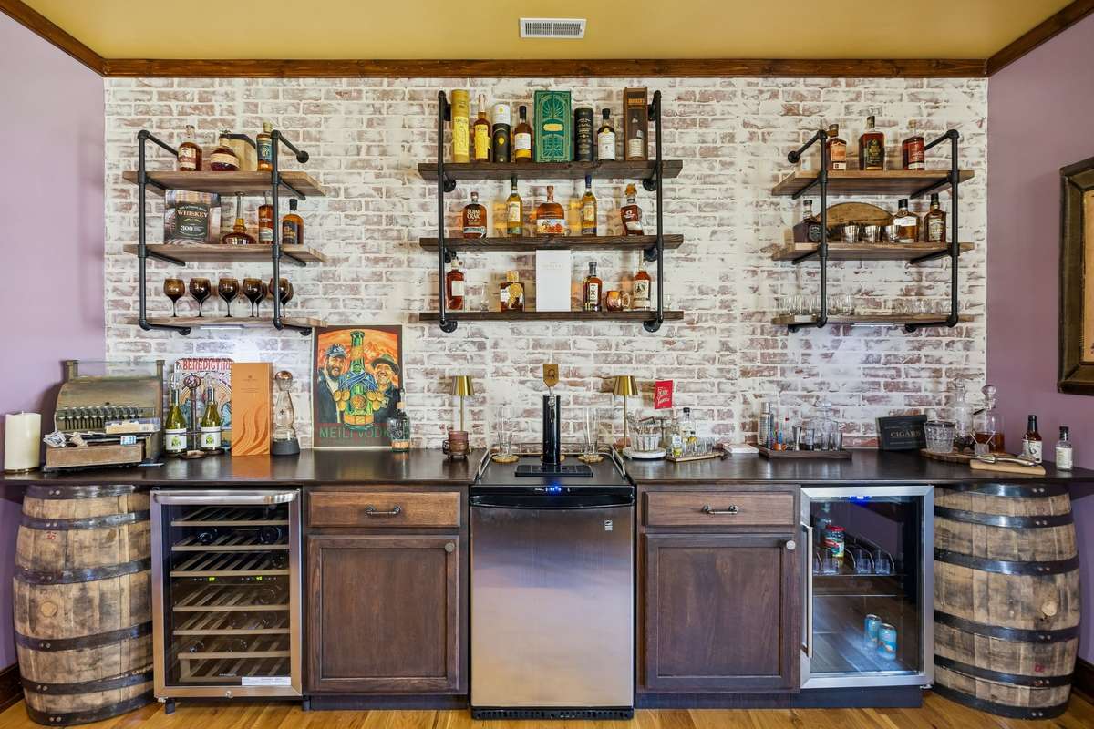 The Kegerator and the two small refrigerators are negotiable. Love the shelving and brick-look wall!