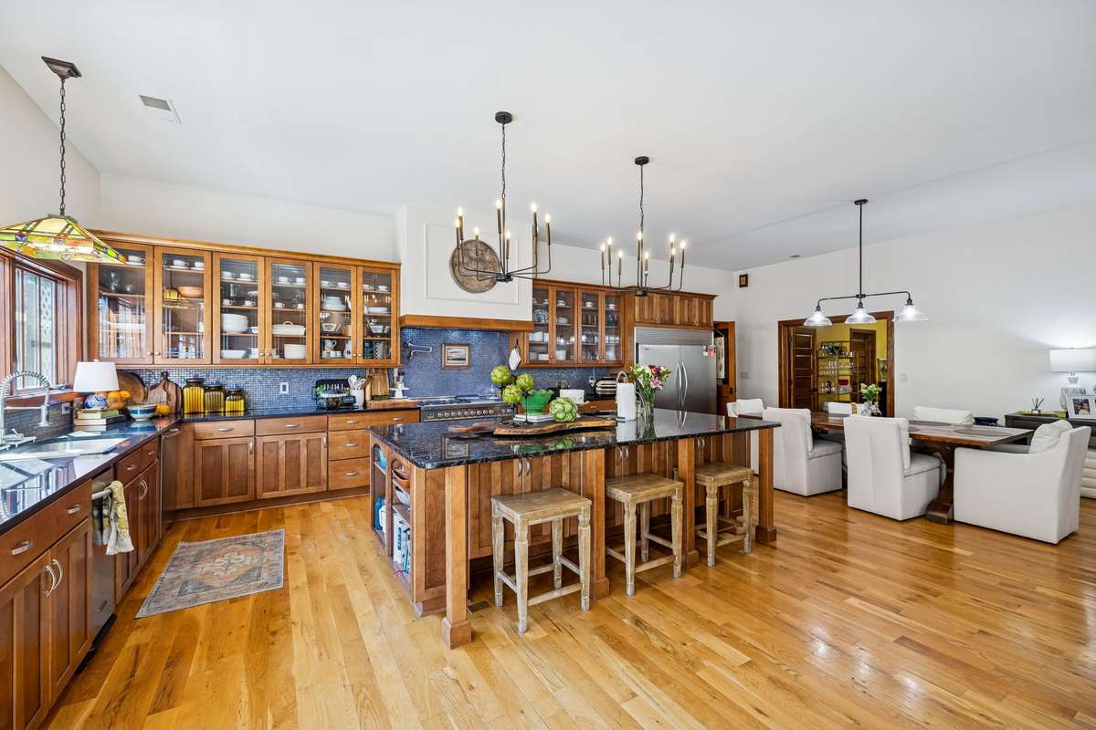 A blue glass backsplash compliments this Kitchen!
