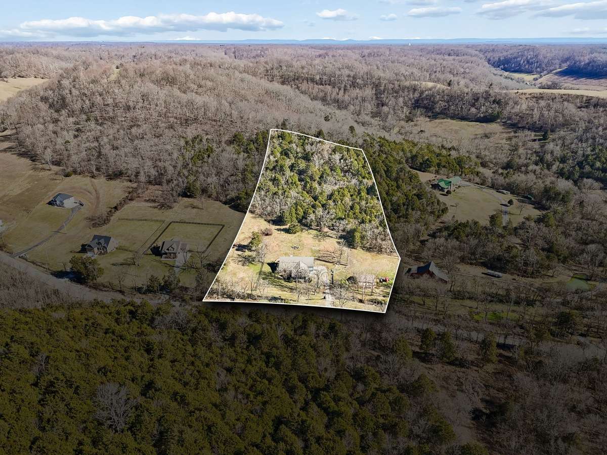 An arial view of this property, which you can see goes into the woods to the top of the hill.