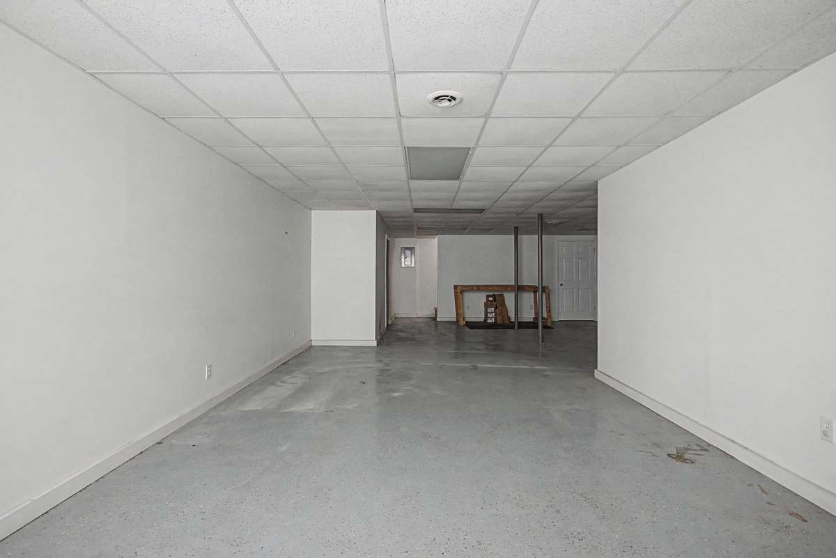 Recessed lighting, sleek floors, and wide open spaces would be perfect place for a home theater, work space, or family room!