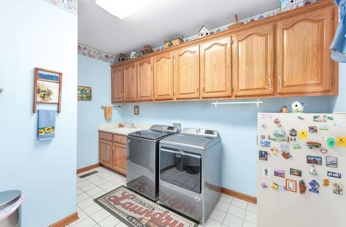 Laundry room with closet and sink.