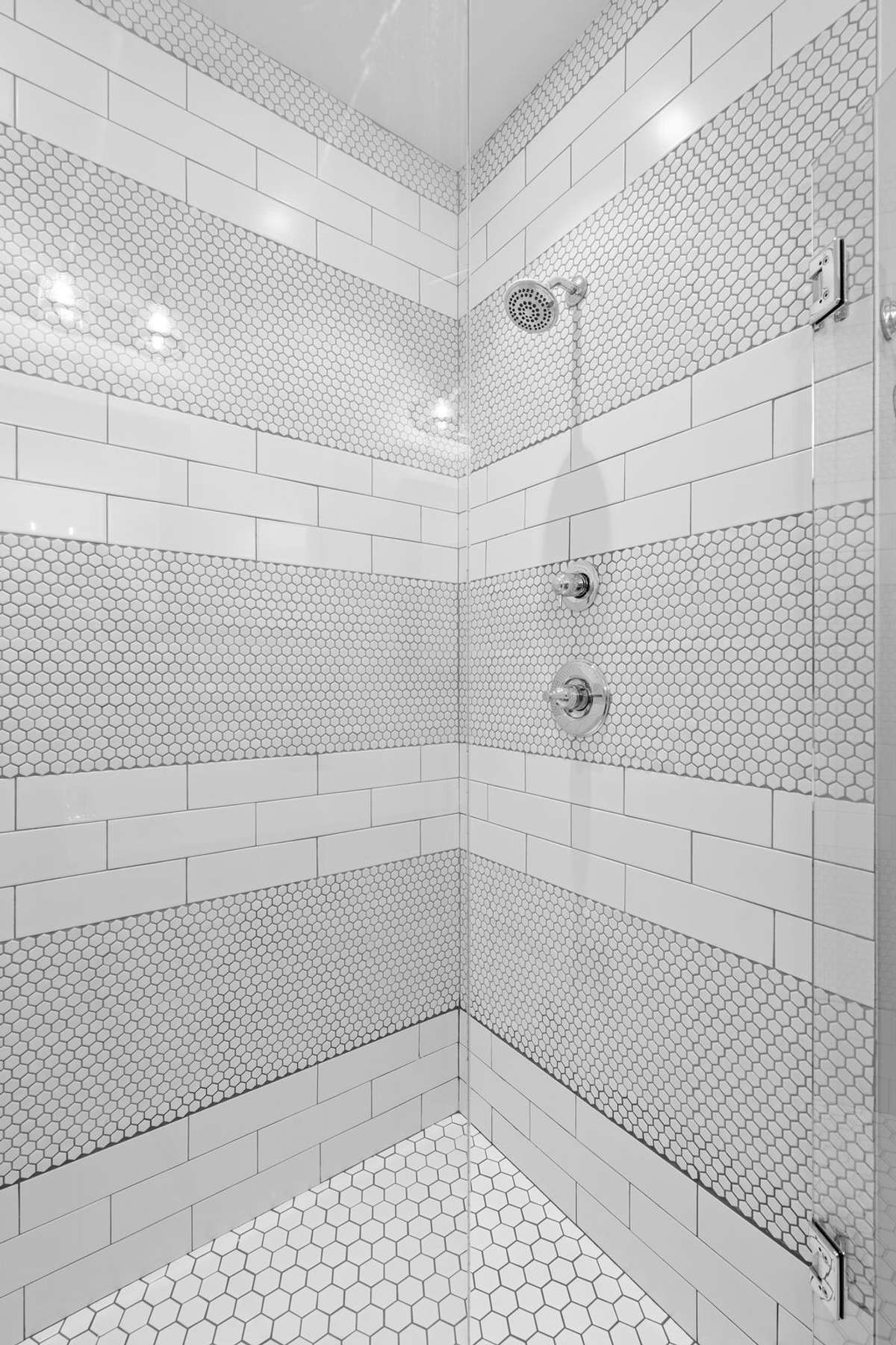 Custom tiled walk-in shower with stylish detail and modern fixtures.