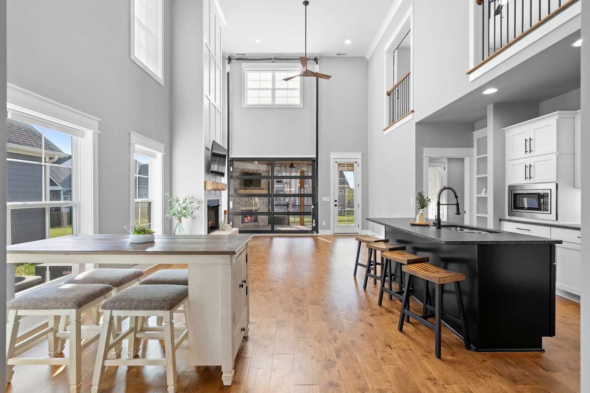 Dramatic two-story living room filled with natural light and designed for everyday living and entertaining.