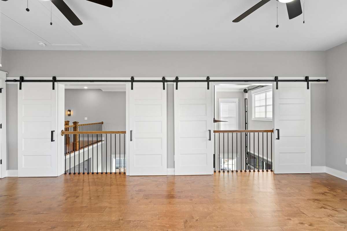 Flexible bonus space with sliding barn doors for added character and functionality.