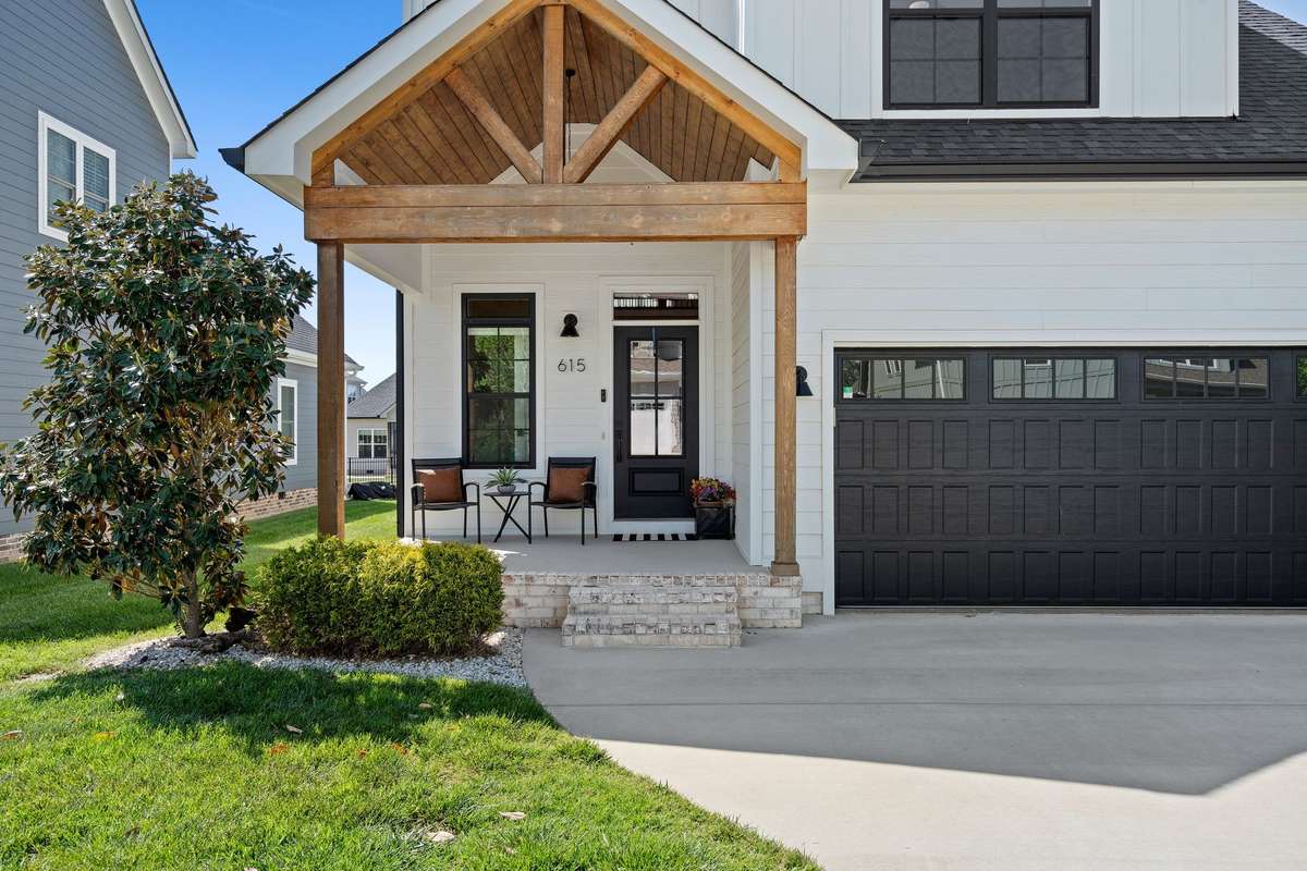 Inviting covered front porch with warm wood accents—perfect for relaxing and enjoying the neighborhood.