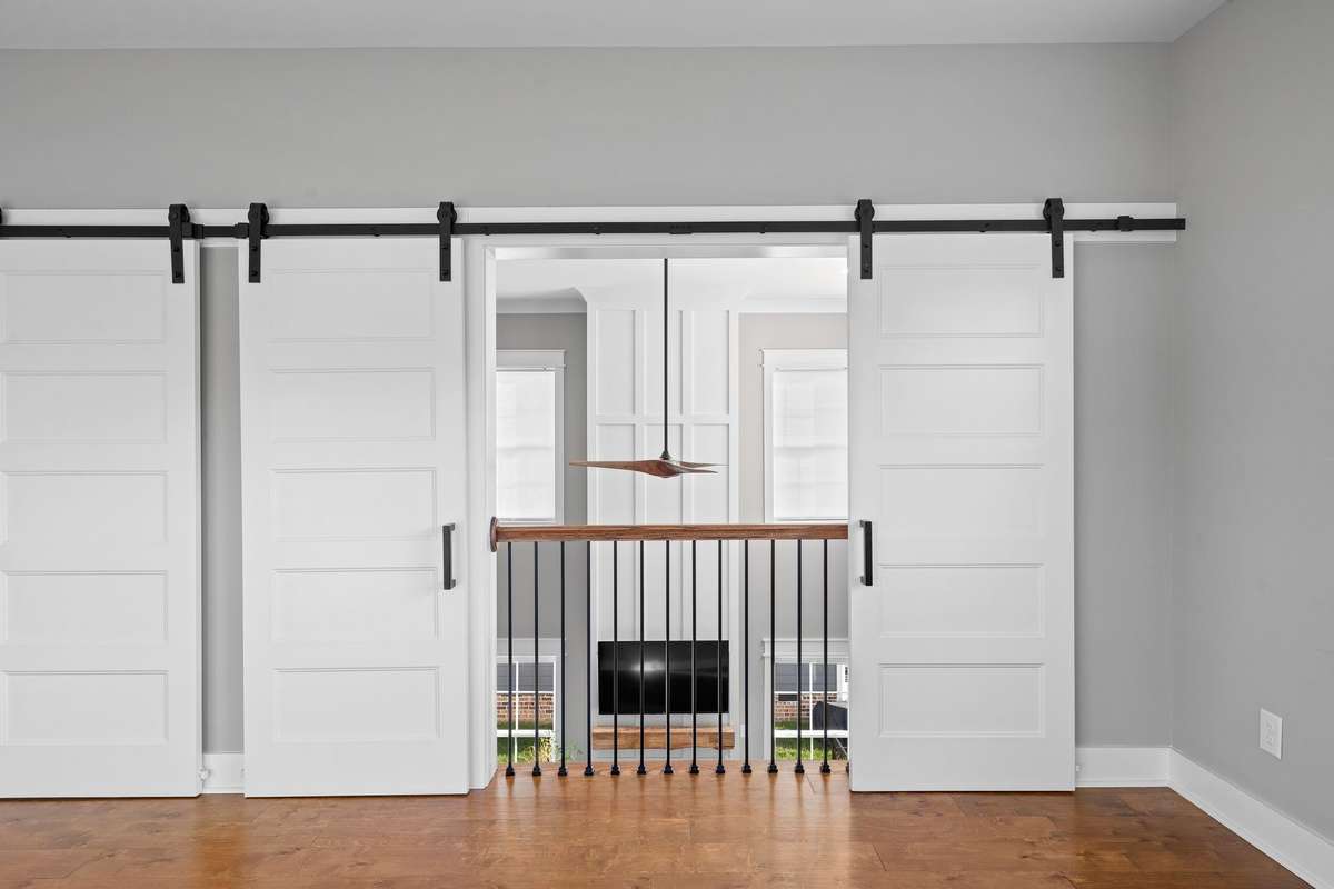 Secondary bedroom with soft natural light and comfortable layout for guests or family.