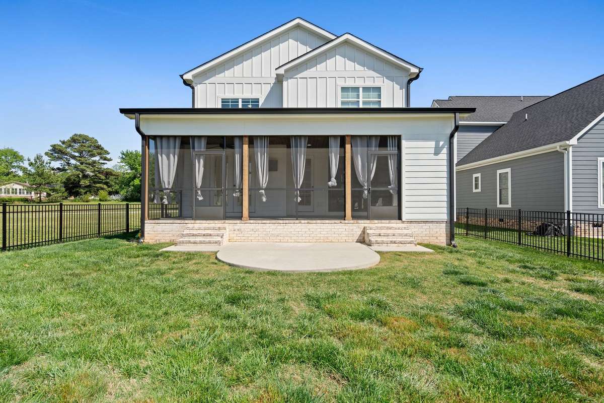 Expansive screened porch offering privacy, comfort, and views of the backyard.