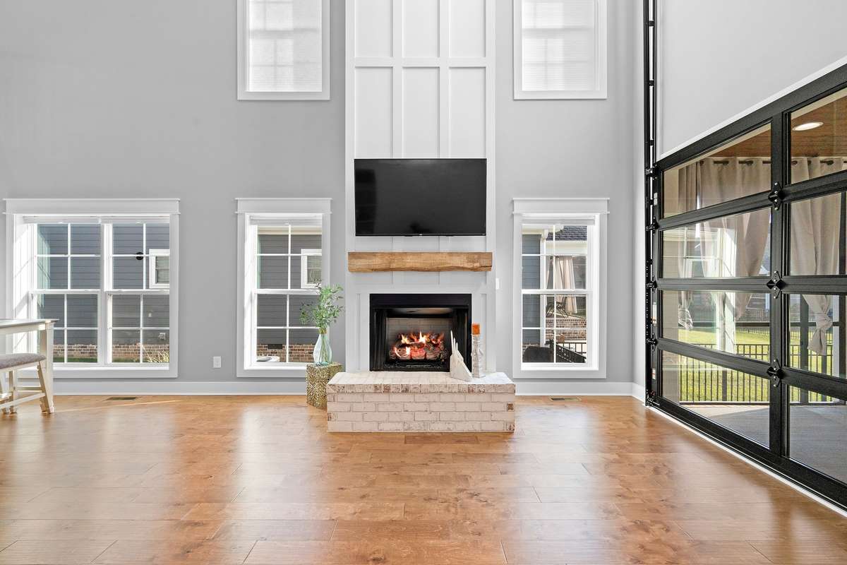 Indoor-outdoor living at its finest with oversized glass garage-style door opening to the screened porch.