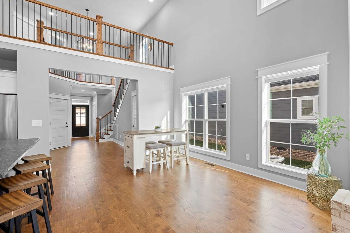 Expansive open living space with balcony overlook adding architectural interest and dimension.